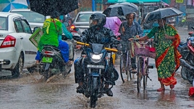 Birbhum: Commuters wade through a waterlogged road during rainfall, in Birbhum, West Bengal. (PTI) Birbhum: Commuters wade through a waterlogged road during rainfall, in Birbhum, West Bengal. (PTI)