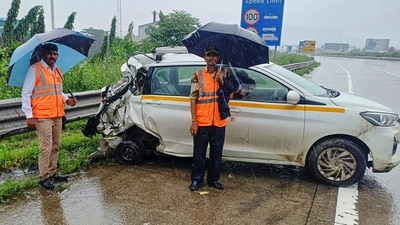 People were seen standing near a damaged car after a speeding container trailer truck rammed into multiple vehicles on the Mumbai Pune Expressway, in Raigad district. (PTI) People were seen standing near a damaged car after a speeding container trailer truck rammed into multiple vehicles on the Mumbai Pune Expressway, in Raigad district. (PTI)