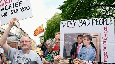 A protester holds a placard with an image of U.S. President Donald Trump and Jeffrey Epstein, as anti-Trump demonstrators gather during a rally organised by the campaign group Stop Trump Coalition, protesting the visit of Donald Trump, in Edinburgh, Scotland, Britain, July 26, 2025. REUTERS/Lesley Martin (REUTERS)