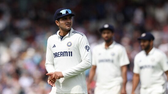 India's captain Shubman Gill (L) leads his team off the field at the end of the first innings on day four of the fourth cricket test match between England and India at Old Trafford, in Manchester (AFP)