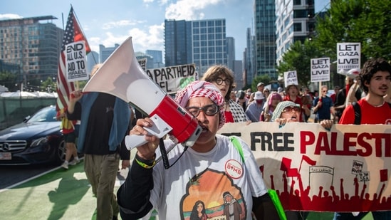 Pro-Palestinian demonstrators march in the seaport district during a ‘Stop starving Gaza’ protest and rally in Boston, Massachusetts on July 25, 2025.(AFP)