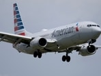 American Airlines Flight AA3023 was bound for Miami and was on the runway when the fire was spotted.