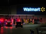 Law enforcement officers are seen stationed outside a Walmart where 11 people were stabbed in a violent attack Saturday, July 26, 2025, in Traverse City, Mich (AP Photo/Ryan Sun)