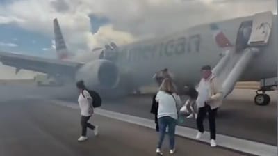 Videos circulating online show visibly panicked passengers sliding down evacuation chutes and running away from the plane Videos circulating online show visibly panicked passengers sliding down evacuation chutes and running away from the plane
