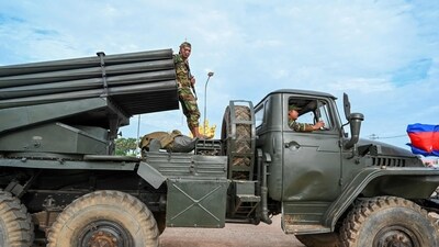 A Cambodian soldier stands on a truck carrying a Russian-made BM-21 rocket launcher travelling along a street in Oddar Meanchey province. (AFP) A Cambodian soldier stands on a truck carrying a Russian-made BM-21 rocket launcher travelling along a street in Oddar Meanchey province. (AFP)