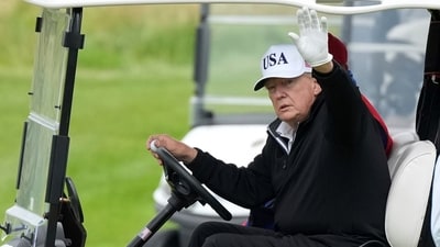 President Donald Trump waves to reporters as he steers his golf cart at the Trump Turnberry golf course in Turnberry, Scotland, Sunday, July 27, 2025.(AP Photo/Alastair Grant) (AP) President Donald Trump waves to reporters as he steers his golf cart at the Trump Turnberry golf course in Turnberry, Scotland, Sunday, July 27, 2025.(AP Photo/Alastair Grant) (AP)