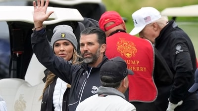 Bettina Anderson and Donald Trump Jr. wave to reporters as President Donald Trump plays golf at the Trump Turnberry golf course in Turnberry, Scotland, Sunday, July 27, 2025.(AP Photo/Alastair Grant) (AP) Bettina Anderson and Donald Trump Jr. wave to reporters as President Donald Trump plays golf at the Trump Turnberry golf course in Turnberry, Scotland, Sunday, July 27, 2025.(AP Photo/Alastair Grant) (AP)