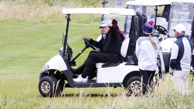 US President Donald Trump waves from a golf cart at the Trump Turnberry golf course in Turnberry, Scotland (Bloomberg) US President Donald Trump waves from a golf cart at the Trump Turnberry golf course in Turnberry, Scotland (Bloomberg)