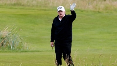 U.S. President Donald Trump waves on the golf course at Trump Turnberry resort in Turnberry, Scotland, Britain. (REUTERS)