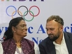 IOA President P.T. Usha talks with Chief Executive Officer Raghuram Iyer during a joint press conference in New Delhi. (AP)