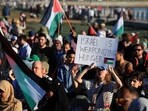 A pro-Palestinian activist holds a placard as they protest over hunger crisis in Gaza, along Sea Point Promenade in Cape Town, South Africa.
