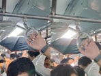 A man was spotted using an open umbrella inside a Mumbai AC train coach, leaving passengers baffled.