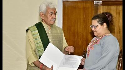 J&K LG Manoj Sinha hands job letter to daughter of  Rajouri ADDC Raj Kumar Thapa on Monday. (HT Photos)