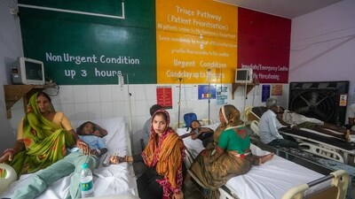 Barabanki: Family members sit beside injured people undergoing treatment at a hospital following a stampede at Avsaneshwar temple. (PTI) Barabanki: Family members sit beside injured people undergoing treatment at a hospital following a stampede at Avsaneshwar temple. (PTI)