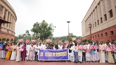 The protest comes just three days after the Opposition leaders had held a demonstration in the Parliament House complex, tearing posters with 'SIR' written on them and putting them in a dust bin. (PTI) The protest comes just three days after the Opposition leaders had held a demonstration in the Parliament House complex, tearing posters with 'SIR' written on them and putting them in a dust bin. (PTI)