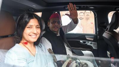 Samajwadi Party MPs Akhilesh Yadav and his wife Dimple Yadav leave the Parliament after a session. (ANI Photo)