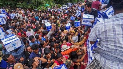 People queue to receive water supplies donated at Batthkao Primary School camp, amid ongoing clashes on the Thai-Cambodian border conflict. (REUTERS)