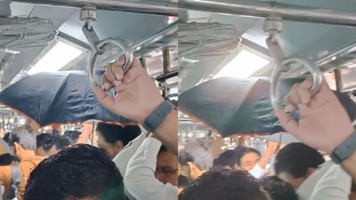 A man was spotted using an open umbrella inside a Mumbai AC train coach, leaving passengers baffled. (@unbelievableboy333/Reddit) A man was spotted using an open umbrella inside a Mumbai AC train coach, leaving passengers baffled. (@unbelievableboy333/Reddit)