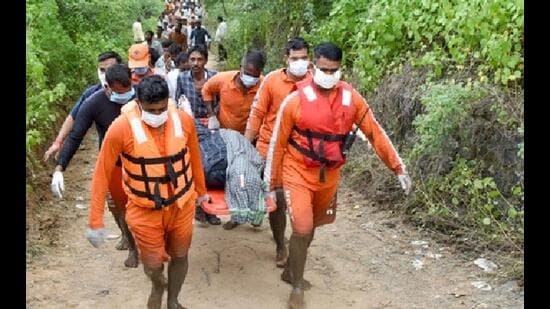 Rescuers bringing the bodies of two of the six victims of an overloaded mini-truck that fell into the Sirhind Canal in Ludhiana district on Sunday night.