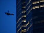 An NYPD helicopter flies overhead as police respond to a shooting incident in the Midtown Manhattan. 