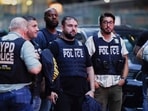 Police officers gather near the scene of a reported shooter situation in the Manhattan borough of New York City, U.S. July 28, 2025. REUTERS/Bing Guan