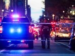 Police and others gather at a crime scene in midtown Manhattan after two people, including a police officer, were shot inside of an office building on July 28, 2025 in New York City.  (Photo by SPENCER PLATT / GETTY IMAGES NORTH AMERICA / Getty Images via AFP)