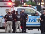 New York Police Department (NYPD) officers are seen as they respond to an incident in the Midtown Manhattan neighborhood of New York on July 28, 2025. Police are investigating an "active shooter" incident, New York Mayor Eric Adams said on X (formerly Twitter) with the NYPD advising residents to "avoid the vicinity of East 52 Street between Park Avenue and Lexington Avenue". (Photo by TIMOTHY A. CLARY / AFP)