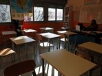 A teacher sits in a classroom, amidst the pandemic as schools promotes social distancing and online learning. 