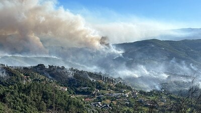 Smoke from a wildfire rises over the hills near the village of Canelas, Arouca region, Portugal (REUTERS)