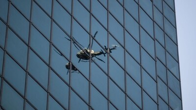 A New York Police Department (NYPD) helicopter reflected in windows near the scene of a shooting at 345 Park Ave. in New York, US, on Monday, July 28, 2025. (Bloomberg)
