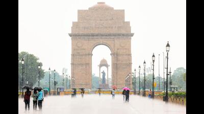 People enjoy the rain at Kartavya Path in New Delhi. (ANI Photo)