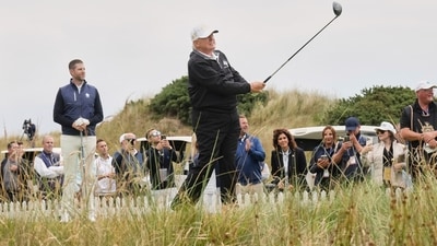 President Donald Trump tees off as Eric Trump, left, stands by during the opening ceremony for the Trump International Golf Links golf course, near Aberdeen, Scotland, on July 29 (AP) President Donald Trump tees off as Eric Trump, left, stands by during the opening ceremony for the Trump International Golf Links golf course, near Aberdeen, Scotland, on July 29 (AP)
