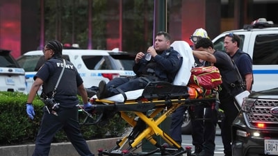 FDNY firefighters wheeled a police officer on a gurney as officers responded to the shooting. (AFP) FDNY firefighters wheeled a police officer on a gurney as officers responded to the shooting. (AFP)