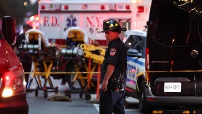 A firefighter stands near emergency vehicles as police respond to a nearby shooting incident in the Midtown Manhattan neighborhood of New York on July 28, 2025. (Photo by CHARLY TRIBALLEAU / AFP) (AFP) A firefighter stands near emergency vehicles as police respond to a nearby shooting incident in the Midtown Manhattan neighborhood of New York on July 28, 2025. (Photo by CHARLY TRIBALLEAU / AFP) (AFP)
