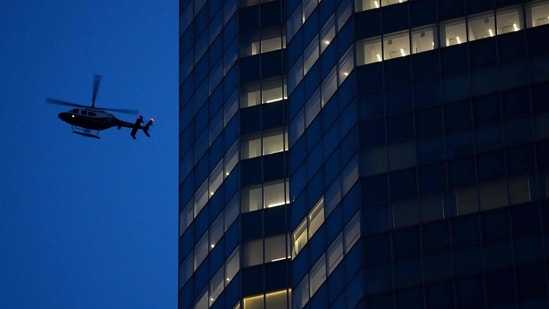 An NYPD helicopter flies overhead as police respond to a shooting incident in the Midtown Manhattan. (AFP)