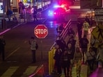 A police officer drives at Santa Monica Pier while warning the public about the regular closure time of the pier amid a tsunami warning in Santa Monica
