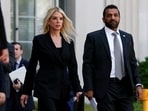 Attorney General Pam Bondi and FBI Director Kash Patel walk to attend a press conference to make an announcement 