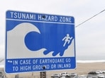 A tsunami hazard zone sign is seen near a beach in El Segundo, California. 