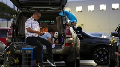 Oahu residents seek refuge from the threat of tsunami in a Walmart parking lot in Kapolei, Oahu, Hawaii, Tuesday, July 29, 2025. AP/PTI(AP07_30_2025_000140A) (AP) Oahu residents seek refuge from the threat of tsunami in a Walmart parking lot in Kapolei, Oahu, Hawaii, Tuesday, July 29, 2025. AP/PTI(AP07_30_2025_000140A) (AP)