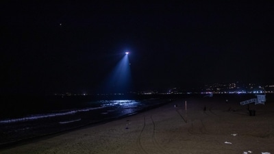 A Los Angeles police department chopper examines waves as it flies over California's Santa Monica beach after a tsunami warning was issued in the area. (Apu GOMES/AFP) A Los Angeles police department chopper examines waves as it flies over California's Santa Monica beach after a tsunami warning was issued in the area. (Apu GOMES/AFP)