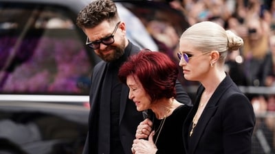 Jack, Sharon and Kelly Osbourne, Ozzy's loving family members, somberly join the procession, laying flowers at the Black Sabbath Bridge bench on Broad Street. The heavy metal pioneer with a successful decade-spanning solo career, was laid to rest in his hometown, Birmingham on July 30. (AP) Jack, Sharon and Kelly Osbourne, Ozzy's loving family members, somberly join the procession, laying flowers at the Black Sabbath Bridge bench on Broad Street. The heavy metal pioneer with a successful decade-spanning solo career, was laid to rest in his hometown, Birmingham on July 30. (AP)