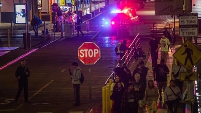 A police officer drives at Santa Monica Pier while warning the public about the regular closure time of the pier amid a tsunami warning in Santa Monica (AFP) A police officer drives at Santa Monica Pier while warning the public about the regular closure time of the pier amid a tsunami warning in Santa Monica (AFP)