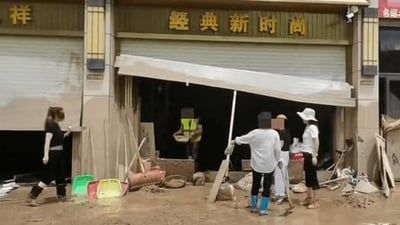 Screengrab from a video circulating on Chinese social media shows people looking for gold jewellery after flash floods. Screengrab from a video circulating on Chinese social media shows people looking for gold jewellery after flash floods.