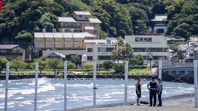 Powerful waves strike the coastline of Fujisawa city, Kanagawa prefecture, as police officers ask a man to evacuate the empty beach. (AFP) Powerful waves strike the coastline of Fujisawa city, Kanagawa prefecture, as police officers ask a man to evacuate the empty beach. (AFP)