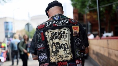 A man wears a battle vest with an image of the members of heavy metal band Black Sabbath, on the day of the funeral cortege of Ozzy Osbourne. (Jack Taylor/REUTERS)