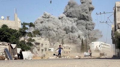 A girl runs from the scene after Israeli strikes on a school sheltering displaced people at the Bureij refugee camp in the central Gaza Strip (REUTERS) A girl runs from the scene after Israeli strikes on a school sheltering displaced people at the Bureij refugee camp in the central Gaza Strip (REUTERS)