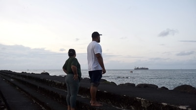 A couple watches the ocean in Samoa's capital city of Apia on July 30, 2025, as a tsunami warning is in effect. (AFP) A couple watches the ocean in Samoa's capital city of Apia on July 30, 2025, as a tsunami warning is in effect. (AFP)