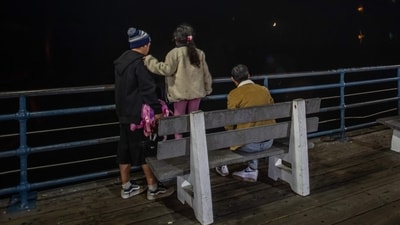 People watch the moon and waves at Santa Monica pier amid a tsunami warning in Santa Monica, California, on July 29, 2025. (AFP) People watch the moon and waves at Santa Monica pier amid a tsunami warning in Santa Monica, California, on July 29, 2025. (AFP)