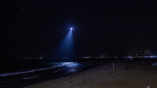 A Los Angeles police department helicopter flies over Santa Monica beach, California, amid a tsunami warning on July 29, 2025. (AFP)