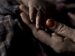 IA Rohingya woman holds her baby boy's hand at a refugee camp in Bangladesh. (AP FILE/REPRESENTATIVE IMAGE) IA Rohingya woman holds her baby boy's hand at a refugee camp in Bangladesh. (AP FILE/REPRESENTATIVE IMAGE)
